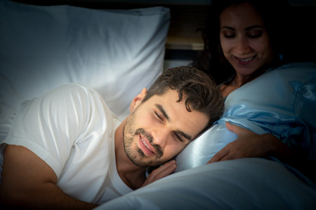 Pregnant woman with husband in bedroom with the atmosphere of having fun talking with the wife's...