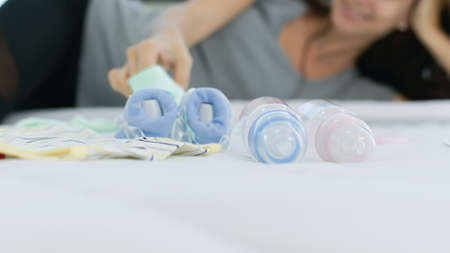 Feeding bottles, clothes, shoes for newborns and essential accessories for new parents.の写真素材