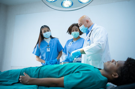 A medical professor is teaching surgery to medical students working at an international medical...