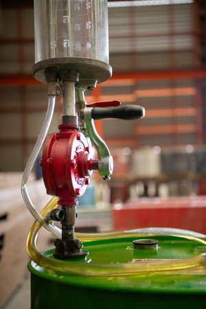 Hand rotate the glass tube with oil on green tank used to reserve oil for the machinery in the...