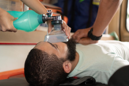 First aid assistance of the ambulance medical team with CPR method and hand-squeezed breathing...