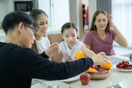 Asian family They are having breakfast together happily in the dining room of the house.の写真素材