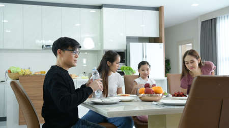Asian family They are having breakfast together happily in the dining room of the house.の写真素材