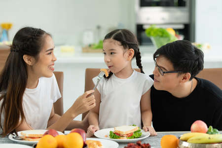 Asian family They are having breakfast together happily in the dining room of the house.の写真素材