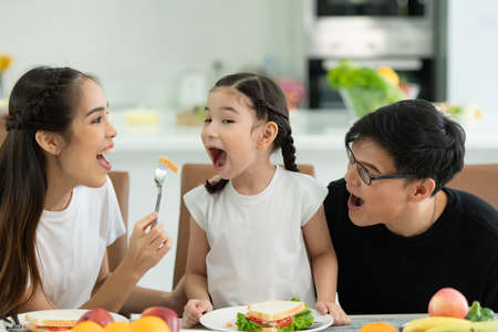 Asian family They are having breakfast together happily in the dining room of the house.の写真素材