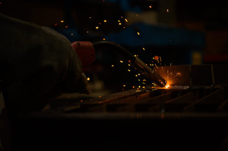 A welder is working to weld metal. to create quality work according to the prescribed form