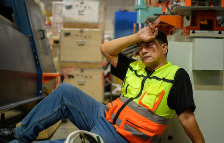 Factory worker Working hard until the symptoms of congenital disease exacerbateの写真素材