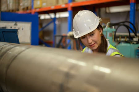 Portrait of woman with large machinery used in heavy industrial plants.の写真素材