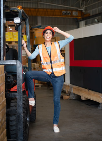 Portrait of an Asian woman with a forklift used to lift heavy objects in a warehouse.
