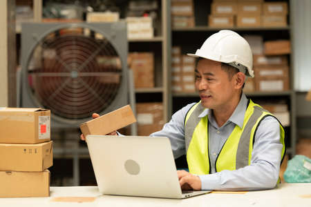 Warehouse Manager, Thinking and reviewing the preparation of products that must be distributed to retailers during the price increase in the market.の写真素材
