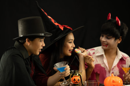 Asian young people attend a Halloween party which is dressed like zombies, devils, witches and...