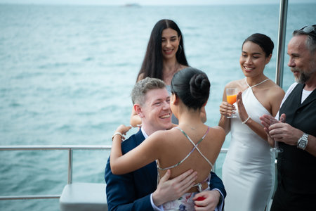 The appropriate time for a white man to propose to marry an Asian woman. on a yacht floating in the lovely water. Among friends who joined in congratulatingの写真素材