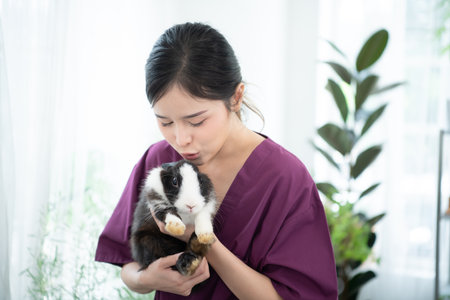 Veterinarian treating sick rabbits He is giving the young bunnies the attention they need to be well and get back to being friendly, robust, and adorable.の写真素材