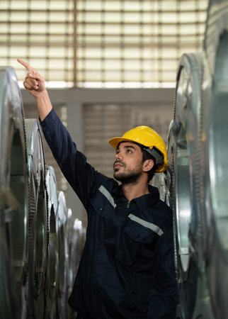 Portrait of a heavy equipment male engineer from a huge industry who came to inspect the metal sheet...