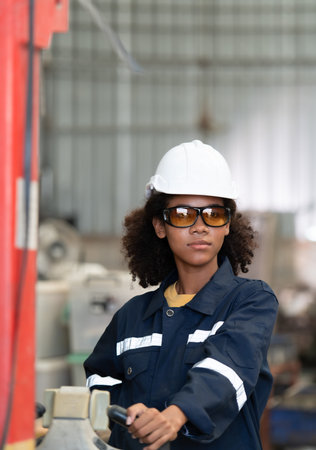 Portrait of a young female engineer in the welding robot industry, posed like a top model.
