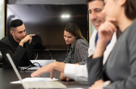 New business people in the conference room are exchanging information with each other along with...