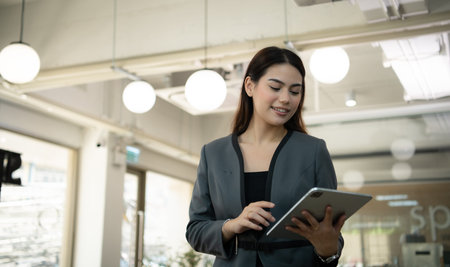 Portrait of Business female rookie in the new entrepreneurial with a tablet as a tool to help in the...