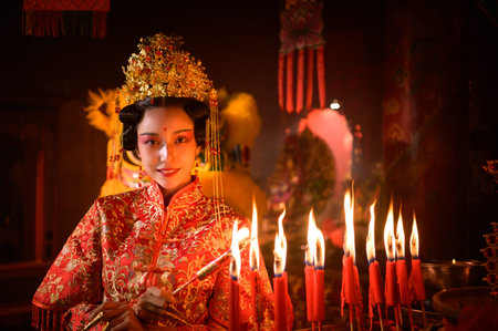 Chinese woman make wishes, pray, and light candles. On the occasion of the annual Chinese New Year...
