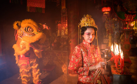 Chinese woman make wishes, pray, and light candles. On the occasion of the annual Chinese New Year...