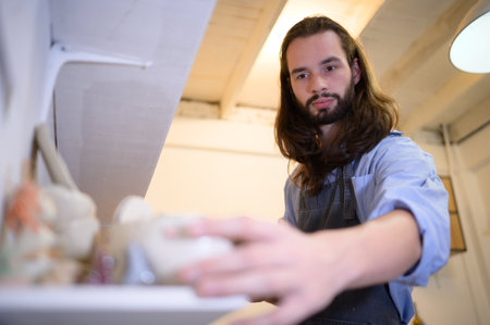 Businessman having a little ceramic business, Checking products in the store to prepare them for sale or to order more production.の写真素材