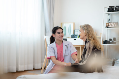 Caregiver for an elderly woman Weekly check-ups at the patient's residence. Ready to give medical advice and talk about various stories, exchange each other happily.の写真素材