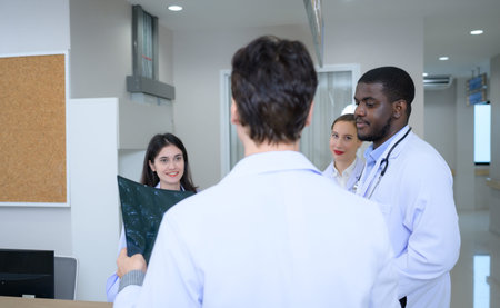 Medical teacher and interns analyzing the x-ray results of the patient's brain. before major surgery...