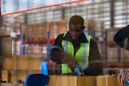 Group of worker in auto parts warehouse Packing small parts in boxes after inspecting the car parts that are ready to be sent to the car assembly plant.の写真素材