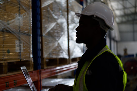 Head of worker in an auto parts warehouse, Examine auto parts that are ready to be shipped to the automobile assembly factory.の写真素材