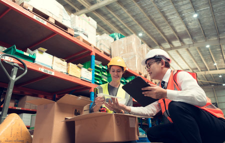 Before exporting to other nations, The product owner meets with the foreman and warehouse personnel to verify their own items held at this warehouse.の写真素材