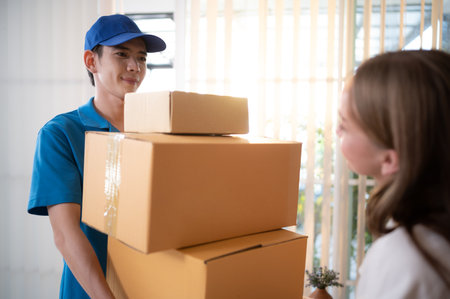 The delivery man brings the goods that the customer purchased and delivers them to the customer's home.の写真素材