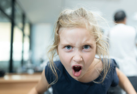 Portrait of little girl with blond hair in the hairdressing salonの写真素材
