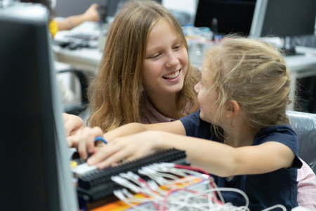 Children using the hand robot technology and having fun Learning the electronic circuit board of hand robot technology, which is one of the STEM courses.の写真素材