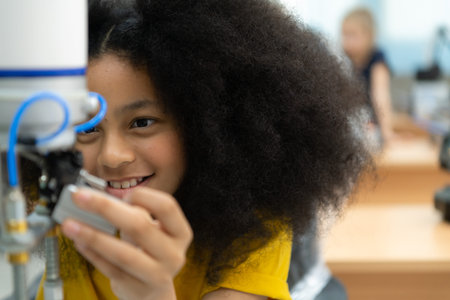 Children using the hand robot technology, Students are studying technology, which is one of the STEM...