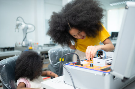 Youngsters utilizing the hand robot technology are having fun learning the electronic circuit board of hand robot technology, which is one of the STEM courses.の写真素材