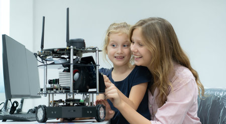 Children using the hand robot technology and having fun Learning the electronic circuit board of...