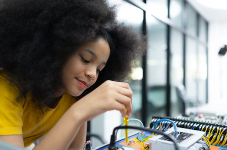Youngsters utilizing the hand robot technology are having fun learning the electronic circuit board of hand robot technology, which is one of the STEM courses.の写真素材