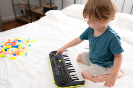 Little boy in his bedroom with a new toy purchased by his parents to help him improve his thinking skills.の写真素材