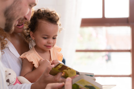 Parents and children relax in the living room of the house. Watch baby happily play with his favorite toy.の写真素材