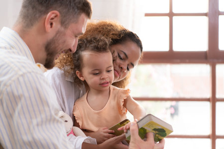 Parents and children relax in the living room of the house. Watch baby happily play with his...