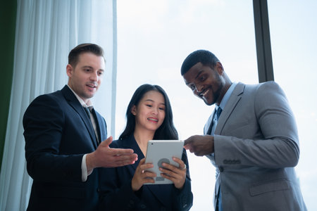 When a group of new businessmen get good news about projects that customers consider accepting proposals. They were overjoyed and delighted with such good news as they sit and rested in the officeの写真素材