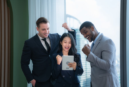 When a group of new businessmen get good news about projects that customers consider accepting proposals. They were overjoyed and delighted with such good news as they sit and rested in the officeの写真素材