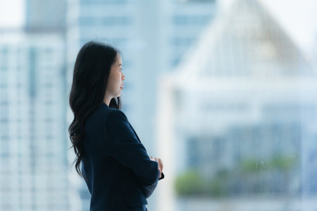 Businesswoman with releasing stressed emotions by relaxing, taking breaks, and looking outside.の写真素材