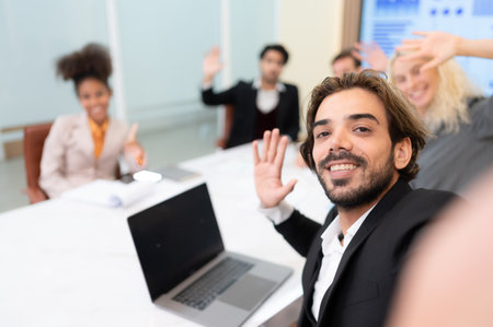 A diverse group of young business people taking selfies In the conference room of an international business company while waiting for the meeting to startの写真素材