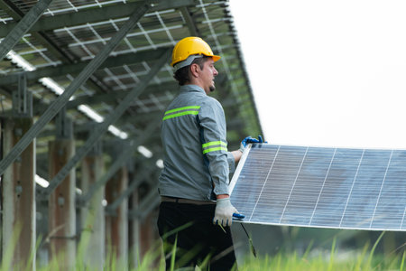 Engineering and technician unloading repaired solar panels to be installed on the rows of solar...