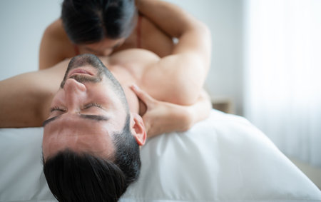 Gorgeous sexy couple enjoying arousing sex before having sex on bed in home bedroom The concept of emotional and love relationships.の写真素材
