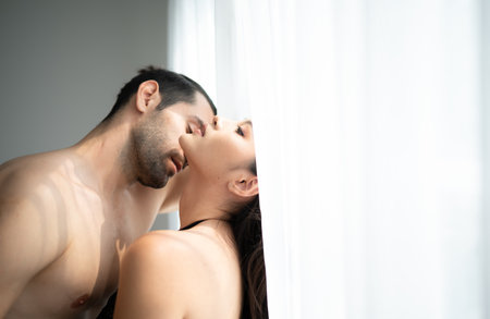 Gorgeous sexy couple enjoying sex in the house's bedroom, Concept of as emotional relationships passion and loveの写真素材