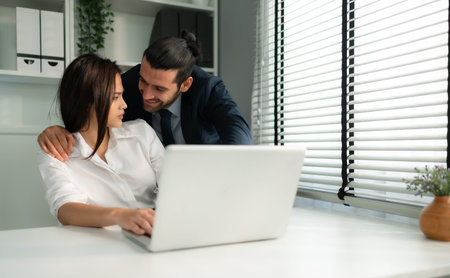 The executive is using his position of power to grope and touch the female employee's body, The concept of harassment and sex in the office.の写真素材