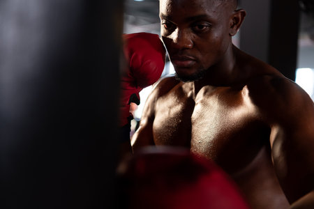 Portrait of boxers must practice their kicking and punching skills with punching bag. To build strength and power of kicking and punching.の写真素材