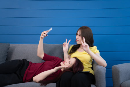 The LGBT couple with vacation activities at home such as chats, teasing, talking, watching movies,...