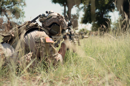 Special forces soldier in camouflage with a pair of weapons that are full of modern technology and complete for battleの写真素材